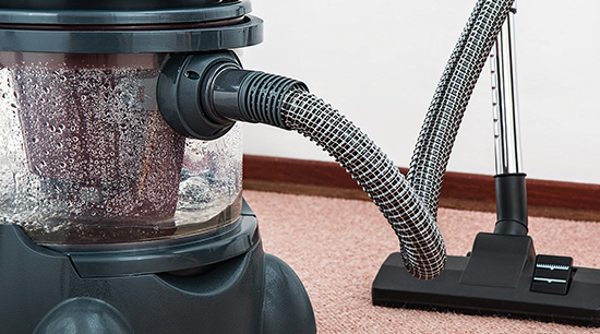 Flood water damage cleanup with vacuums and steam cleaners