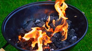 Lighting charcoal in backyard barbecue grill