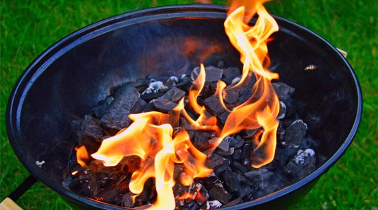 Lighting charcoal in backyard barbecue grill