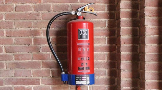 ABC fire extinguisher wall mounted by barbecue grill
