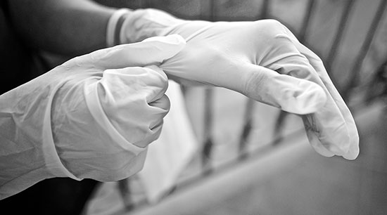 Gloves are part of needed protective equipment to work on a clogged toilet