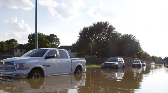 Hurricane damage flooded street and cars