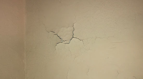 Water leaks can appear as cracking in paint and or drywall
